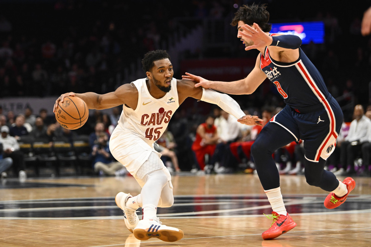 Feb 7, 2024; Washington, District of Columbia, USA; Cleveland Cavaliers guard Donovan Mitchell (45) dribbles as Washington Wizards forward Deni Avdija (8) defends during the first half at Capital One Arena.